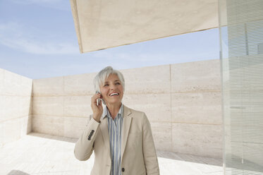 Spain, Mallorca, Senior Businesswoman using mobile phone - WESTF12805