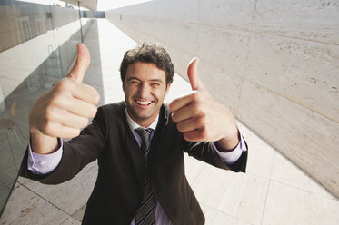 Spain, Mallorca, Businessman, thumbs up, laughing, portrait - WESTF12745