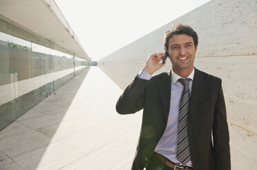 Spain, Mallorca, Businessman using mobile phone, portrait - WESTF12739