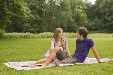 Germany, Bavaria, Starnberger See, Young couple sitting in meadow - RNF00028