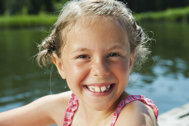 Italy, South Tyrol, Portrait of a girl (6-7) smiling, portrait, close-up - WESTF13360