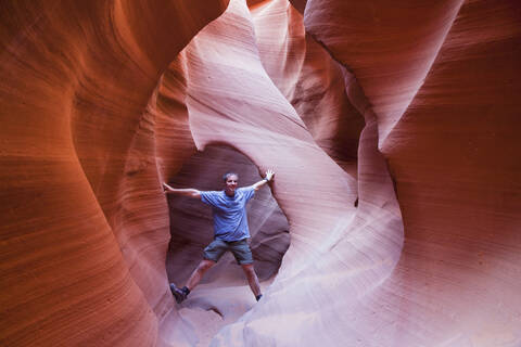 USA, Arizona, Man standing in Lower Antelope Canyon stock photo