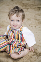 Germany, Berlin, Boy (2-3) sitting in sandbox - WESTF13580