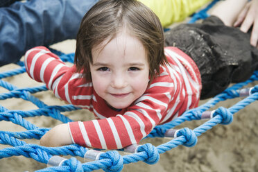 Germany, Berlin, Boy (3-4) lying on jungle gym, portrait - WESTF13564