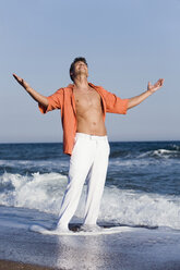 Turkey, Young man on beach with arms outstretched - RDF00974