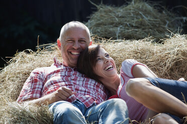 Germany, Bavaria, Couple lying on haystack - WESTF13171