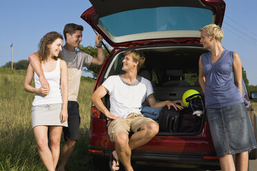 Germany, Bavaria, Group of friends standing by car, smiling, portrait - LDF00806