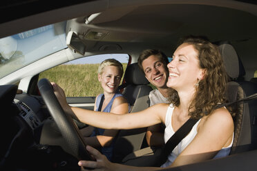 Germany, Bavaria, Young people riding a car, laughing, side view, portrait - LDF00789