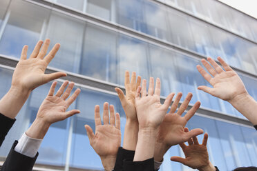 Germany, Hamburg, Business people cheering, hands raised, close-up - WESTF13895