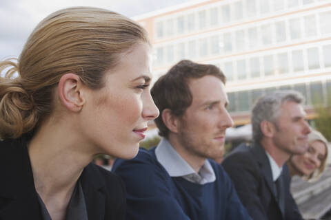 Germany, Hamburg, Four Business people in a row, portrait, close-up stock photo