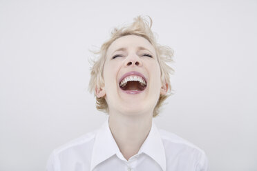 Woman laughing eyes closed, portrait - TCF01271