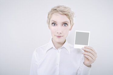 Woman holding polaroid picture - TCF01266