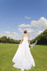 Germany, Bavaria, Bride walking in park, rear view - NHF01166
