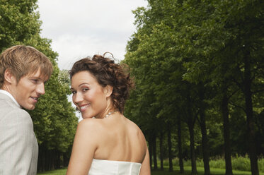 Germany, Bavaria, Wedding couple in park, smiling, portrait, close-up - NHF01141