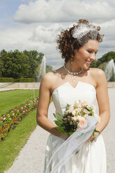 Germany, Bavaria, Bride in park, smiling, portrait - NHF01133