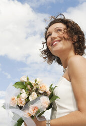 Germany, Bavaria, Smiling Bride with bouquet, outdoors, portrait, close-up - NHF01123