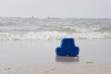 Deutschland, Schleswig Holstein, Amrum, Plastikauto am Sandstrand - AWDF00428