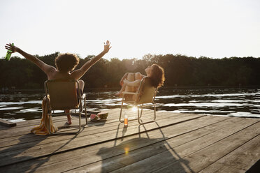 Germany, Berlin, Young couple relaxing on chairs - VVF00086