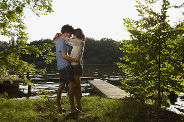 Germany, Berlin, Young Couple embracing by River Spree, view - VVF00081