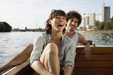 Germany, Berlin, Young couple on motor boat, laughing, portrait - VVF00074