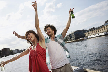 Germany, Berlin, Young couple on motor boat, having fun - VVF00062