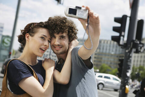 Germany, Berlin, Young couple taking a photograph of themselves stock photo