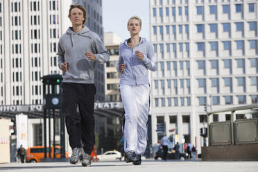 Germany, Berlin, Young couple jogging together - SKF00061