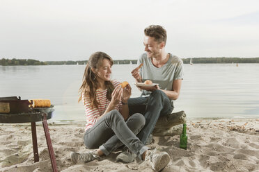Germany, Berlin, Lake Wannsee, Young couple having a barbecue - WESTF13977
