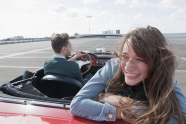Germany, Berlin, Couple driving in cabriolet, smiling, portrait - WESTF13946