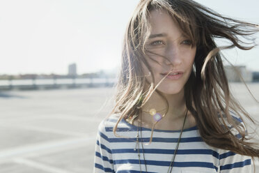 Germany, Berlin, Young woman on deserted parking level, portrait, close-up - WESTF13921