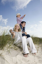 Germany, Schleswig Holstein, Amrum. Family relaxing in sand dunes - RBF00154