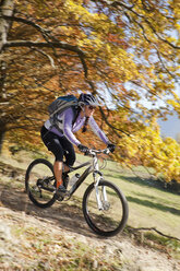 Germany, Bavaria, Woman mountain biking - FFF01095