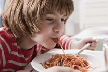 Germany, Cologne, Boy (6-7) eating spaghetti, portrait, close-up - WESTF14359