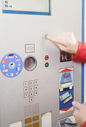 Germany, Bavaria, Munich, Person using ticket machine in subway station - WESTF14219