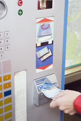 Germany, Bavaria, Munich, Person at ticket machine in subway station - WESTF14218