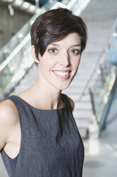 Germany, Bavaria, Munich, Business woman at subway station, smiling, portrait, close-up - WESTF14163