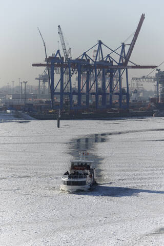 Germany, Hamburg, Ice breaker moving ahead breaking ice sheet stock photo