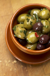 Olives with herbs in bowl, elevated view - SCF00375