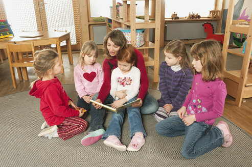 Germany, Female nursery teacher and children in nursery - RNF00124