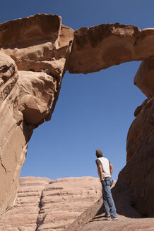 Man looking at rock formation - NHF01196