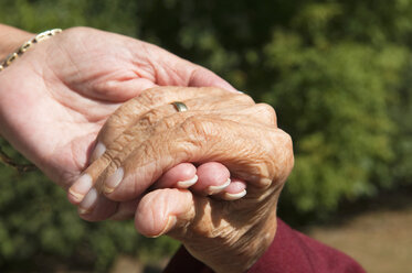 Senior women holding hands, close-up - NHF01191