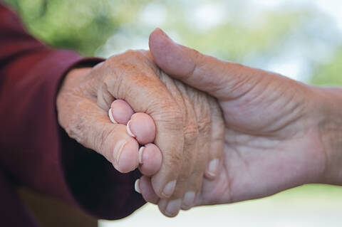 Senior women holding hands, close-up stock photo