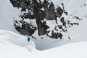Austria, Arlberg, Man skiing downhill, doing jump - MIRF00028