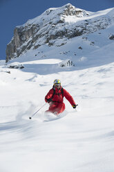 Austria, Arlberg, Man skiing downhill - MIRF00024