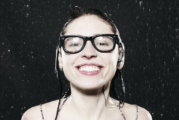 Woman with spectacles in rain, smiling. - FMKF00077