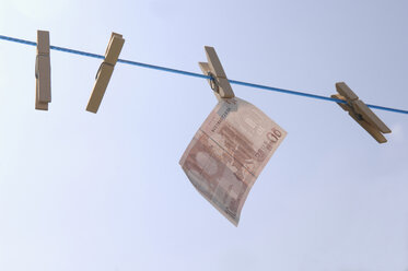 Germany, Euro banknote hanging on clothesline - CRF01843