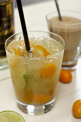 Cocktail with fruit and straw, close up. - CHKF00957