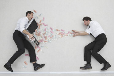 Two businessmen, one of them holding money case, side view, portrait, elevated view - BAEF00041