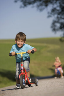 Austria, Mondsee, Girl and boy (2-5) riding bicycle - WWF01264