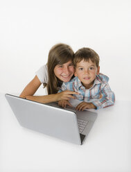 Girl and boy (2-5) with laptop, smiling, portrait - WWF01233